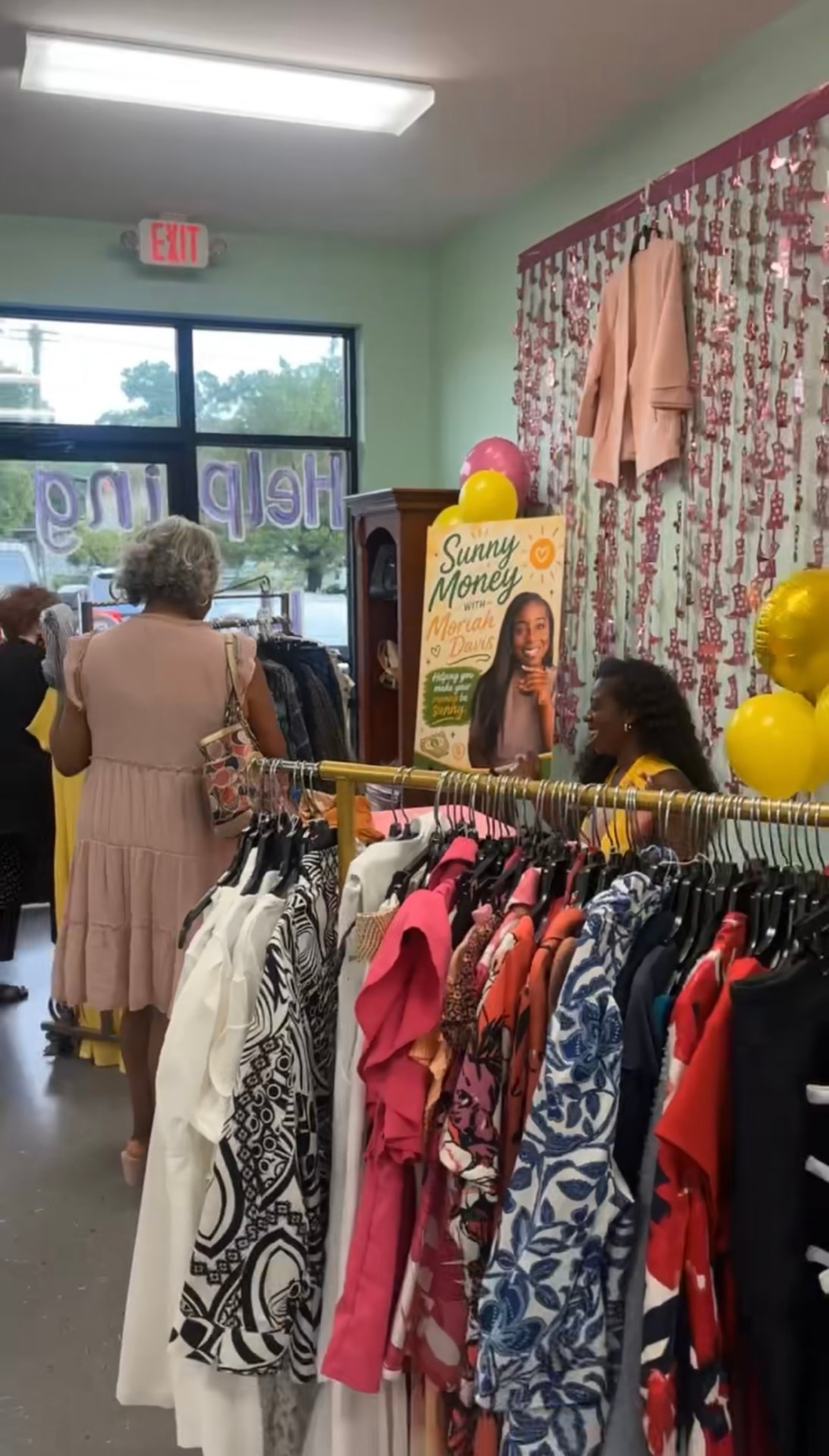 Colorful clothing racks inside Helping Hands Boutique during a Moriah's Closet event