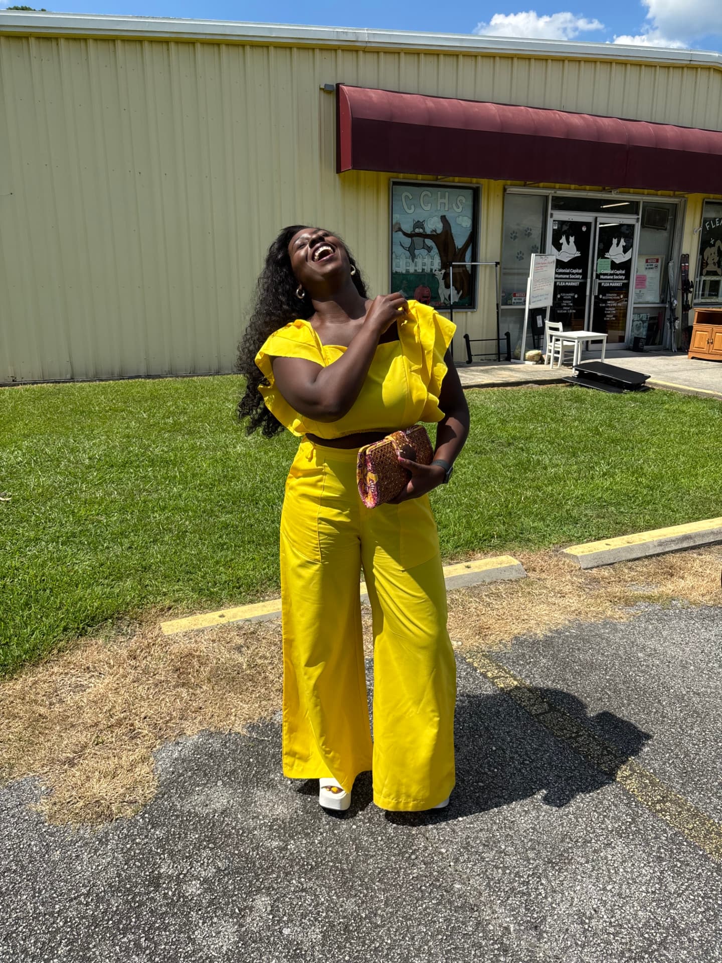 Moriah Davis laughing in a bright yellow two-piece set with wide-leg pants